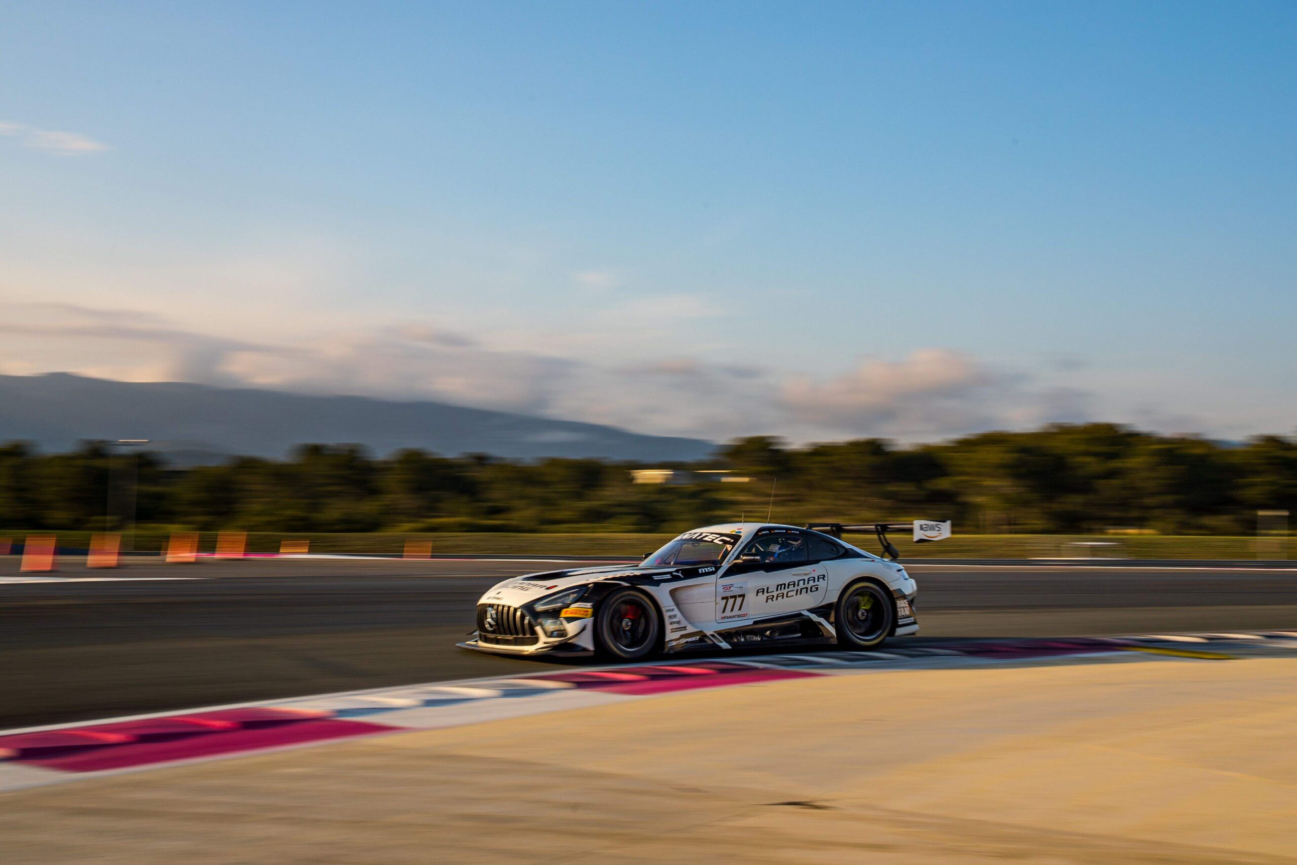 A race car speeds along a race track