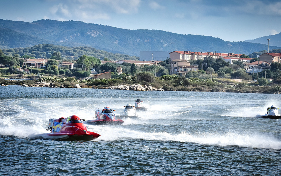 Boats speeding across water with water spraying