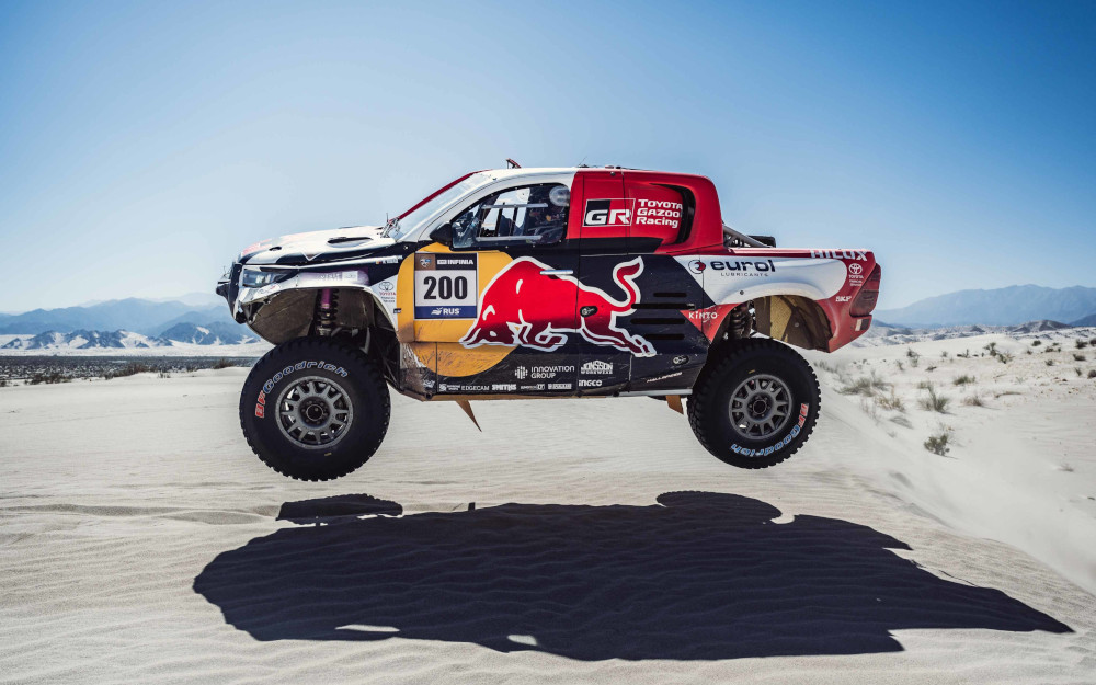 A rally car mid-air in the desert
